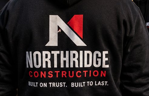 Close-up of a custom printed logo on the back of a crew hoodie
