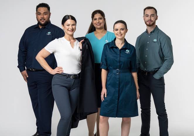 Finance and corporate team in branded uniforms from SUQ MEDIA
