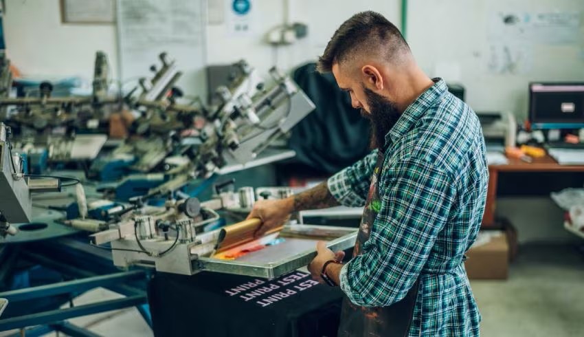 Screen printing being completed in-house at the SUQ MEDIA Calgary shop